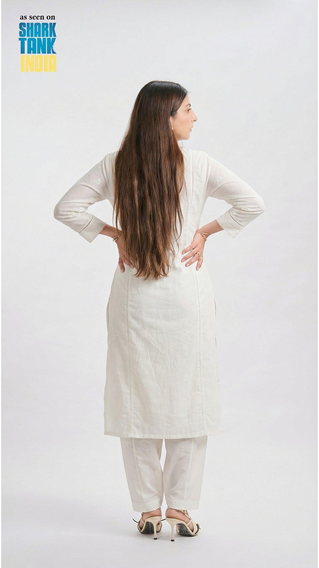 Woman wearing a white outfit on a plain background