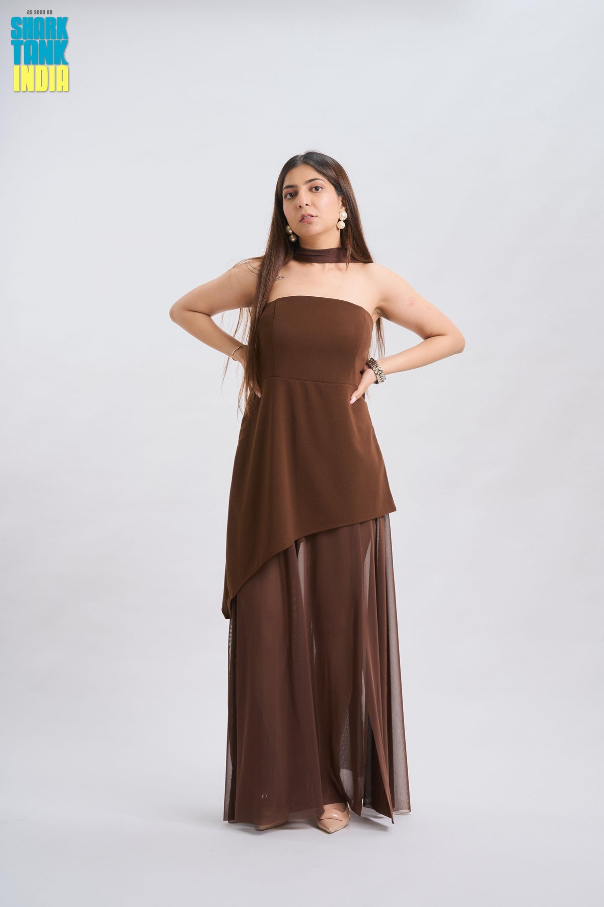Woman wearing a brown dress on a white background