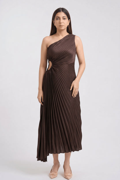 A woman modeling a dark brown one-shoulder pleated midi dress with a side cutout, standing against a light gray studio background.