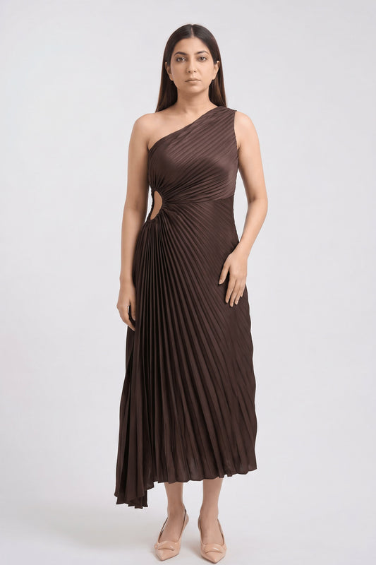 A woman modeling a dark brown one-shoulder pleated midi dress with a side cutout, standing against a light gray studio background.