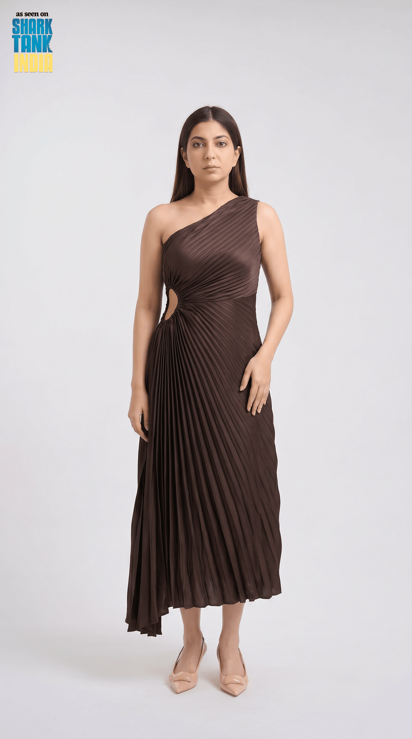 Woman wearing a brown one-shoulder dress on a white background