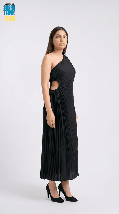 Woman wearing a black one-shoulder dress with cut-out design on a white background