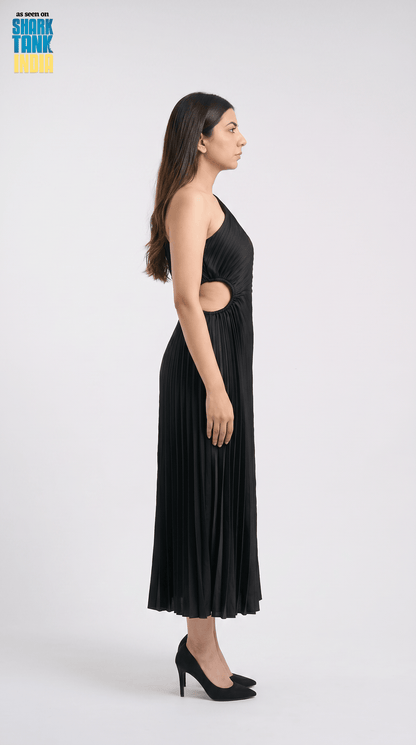 Woman wearing a black dress with cut-out design on a white background