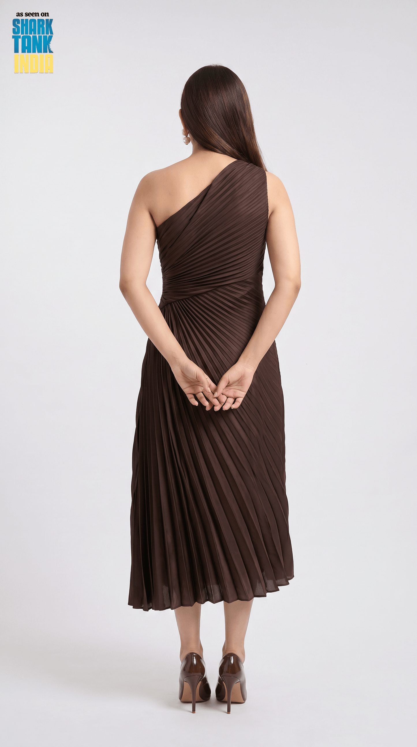 Woman wearing a brown one-shoulder dress on a white background