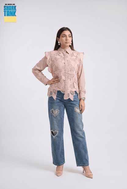 Woman wearing a pink lace blouse and blue jeans on a white background with 'Shark Tank' branding.