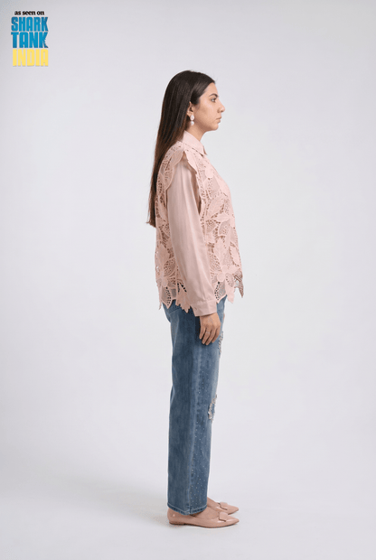 Woman wearing a pink lace blouse and blue jeans on a white background with 'Shark Tank' branding.