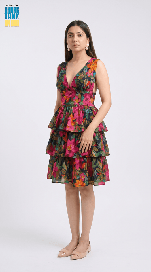 Woman wearing a colorful tiered dress on a white background