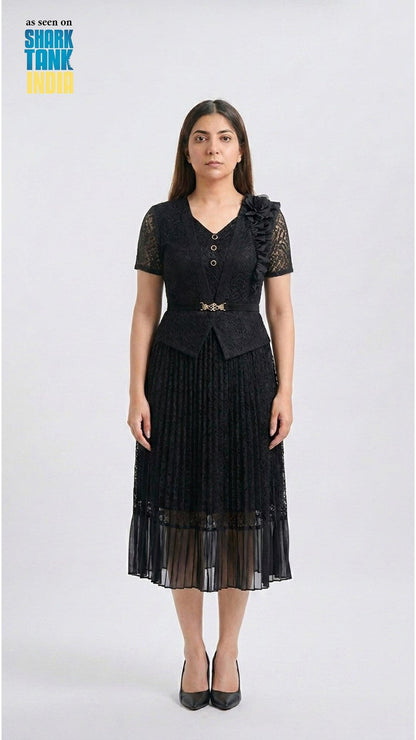 Woman wearing a black dress with lace details on a white background