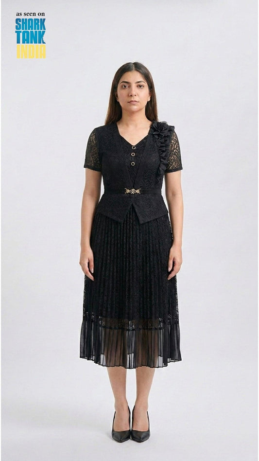 Woman wearing a black dress with lace details on a white background