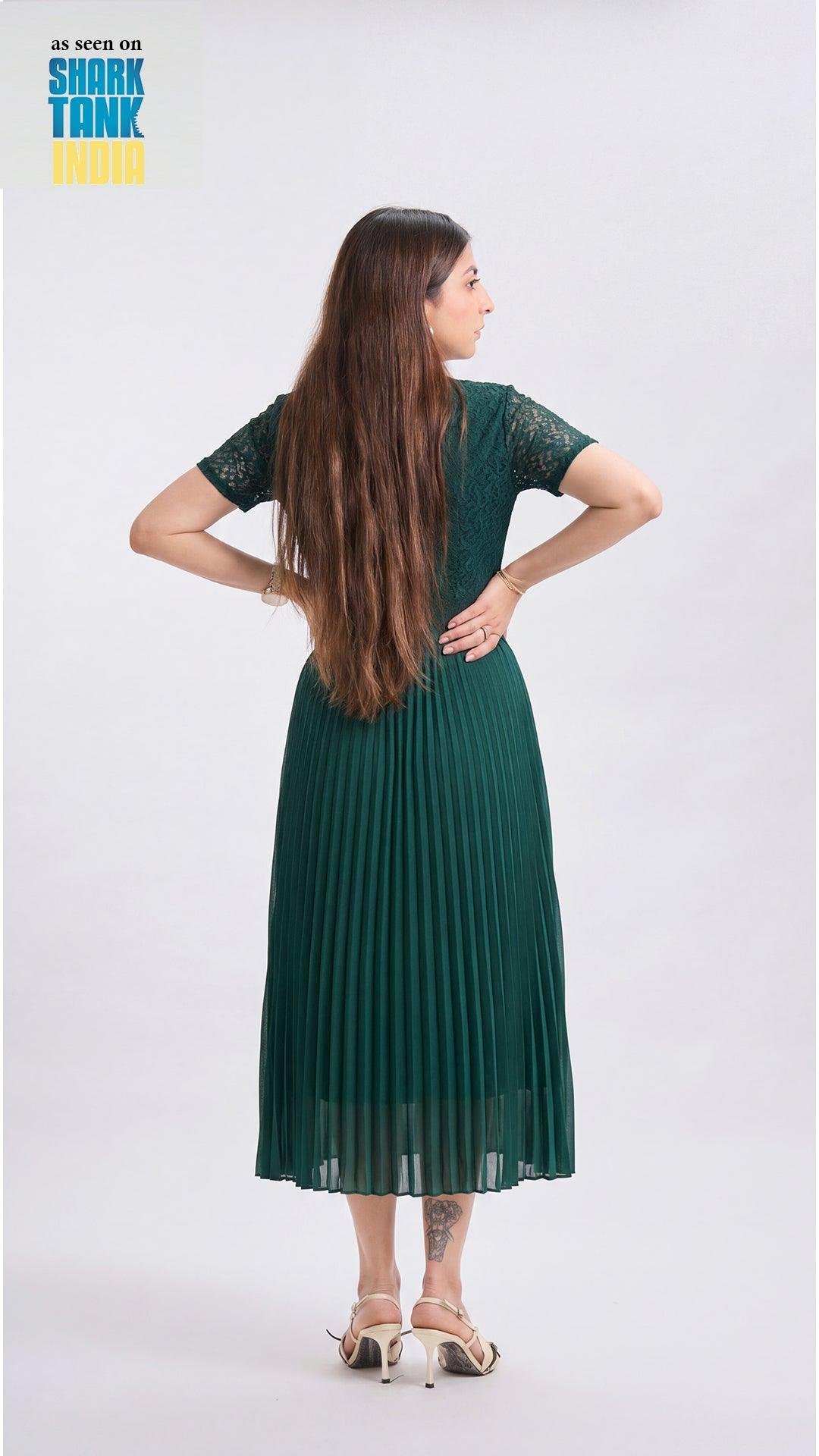 Woman wearing a green dress with a plain background