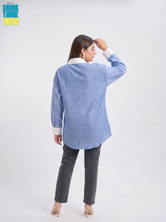 Woman wearing a blue checkered shirt and gray pants on a white background