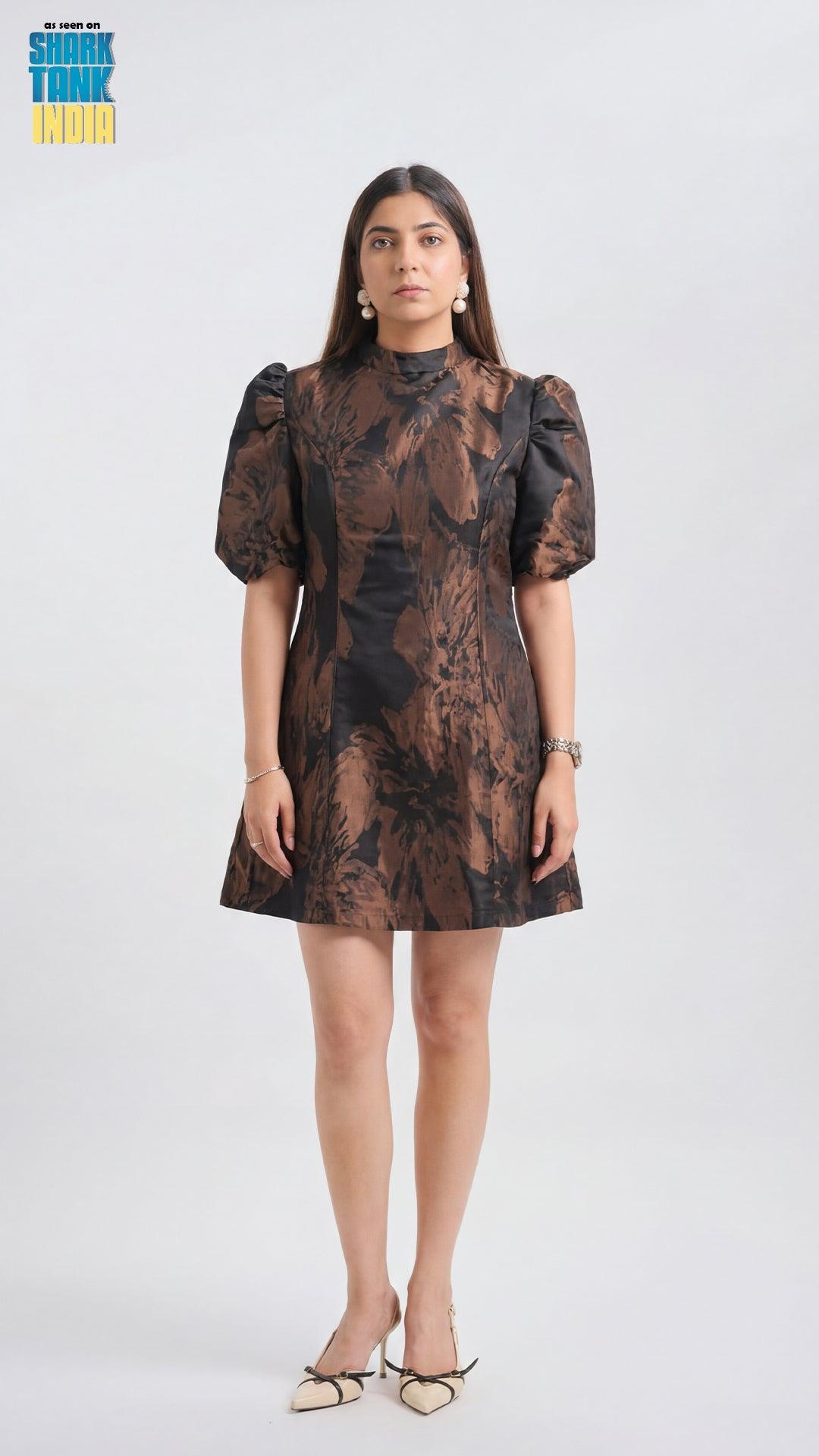Woman wearing a patterned dress on a white background