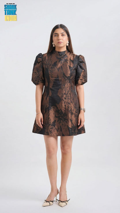 Woman wearing a patterned dress on a white background