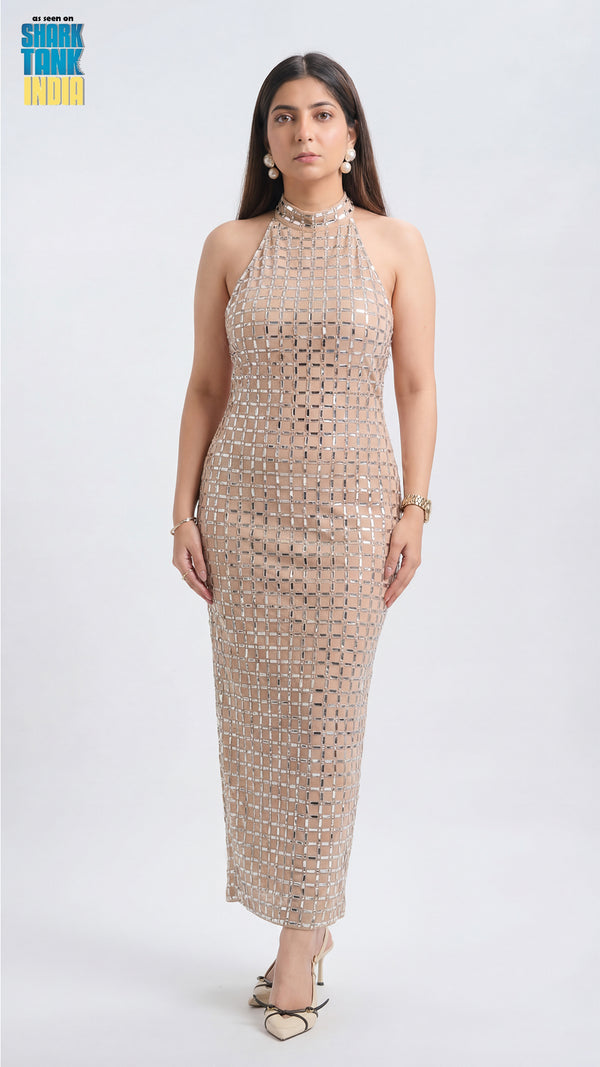 Woman wearing a patterned halter neck dress on a white background