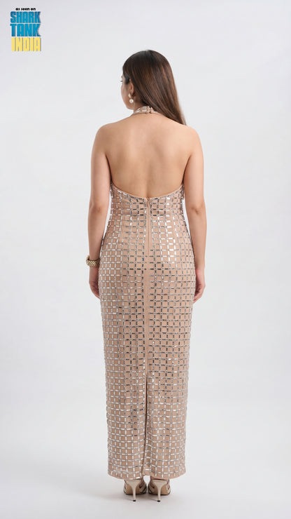 Woman wearing a strapless, patterned dress on a white background