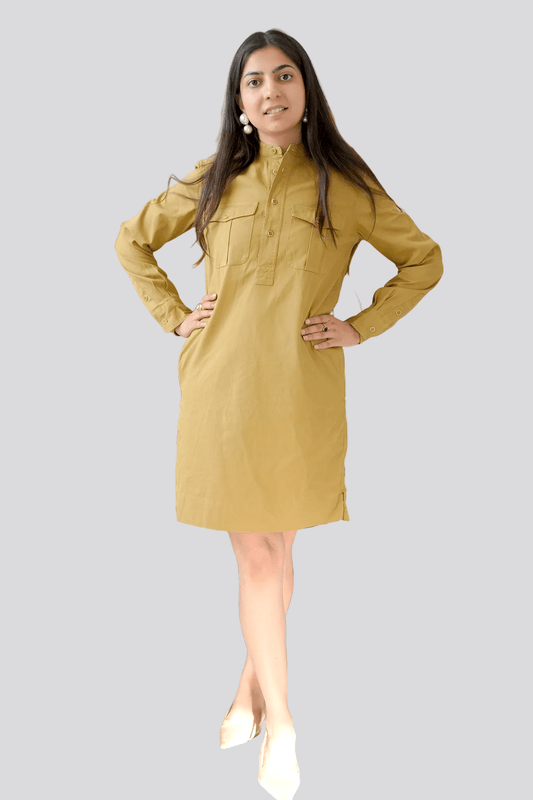 Woman wearing a mustard yellow dress against a plain background