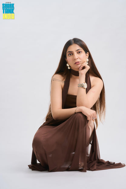Woman in a brown dress posing on a white background