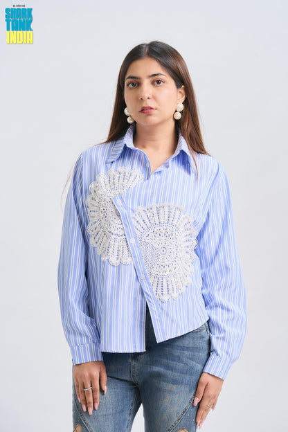 Woman wearing a blue striped shirt with decorative elements on a white background