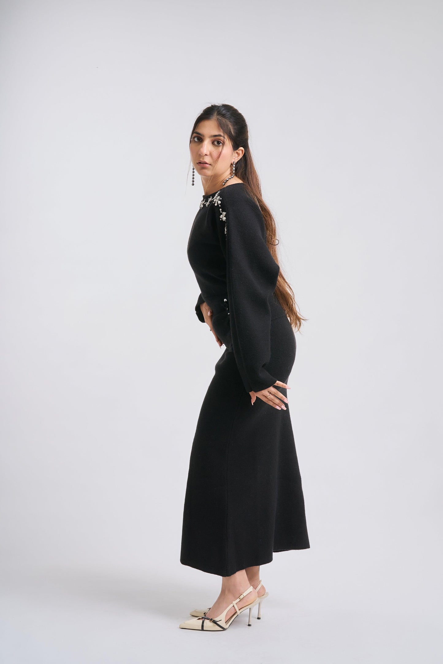 Woman wearing a black dress on a white background