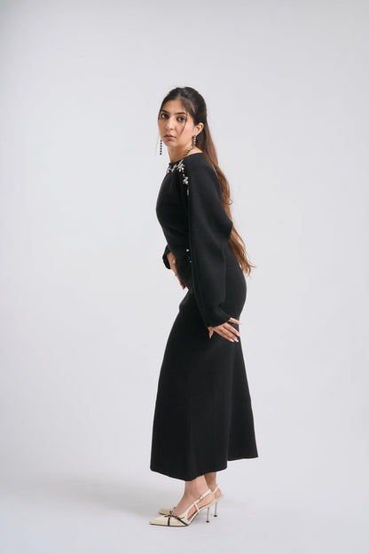 Woman wearing a black dress on a white background