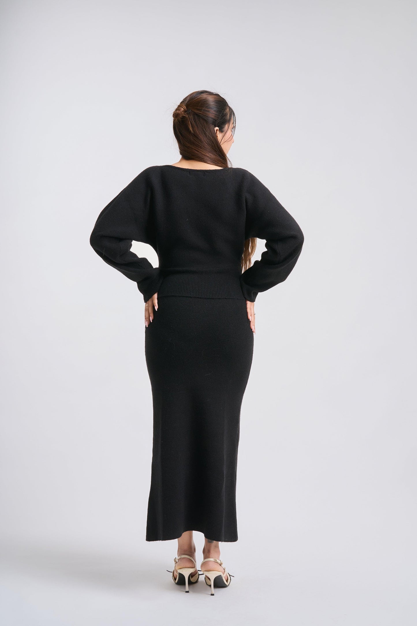 Woman wearing a black outfit on a white background