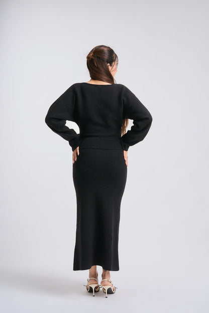 Woman wearing a black outfit on a white background
