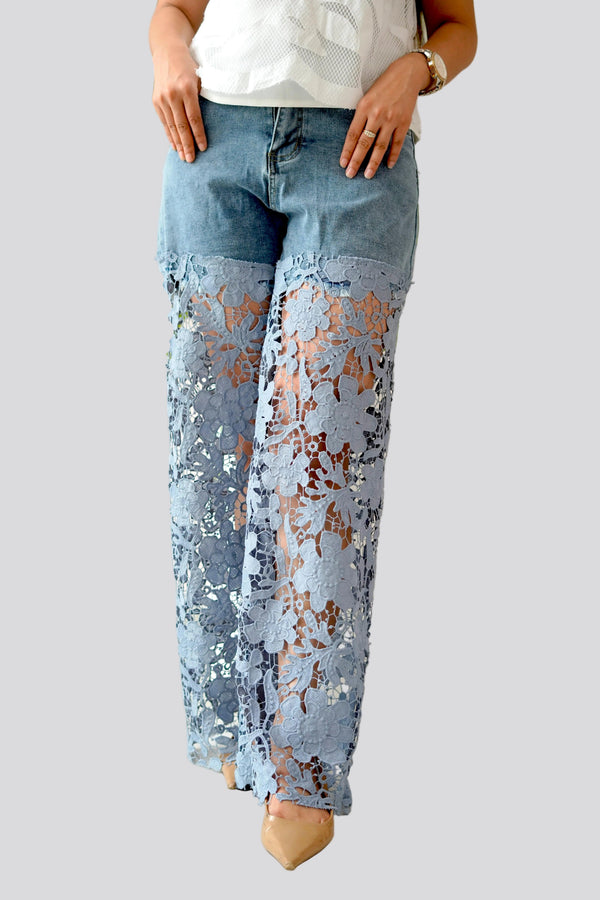Light blue jeans with floral pattern on a plain background