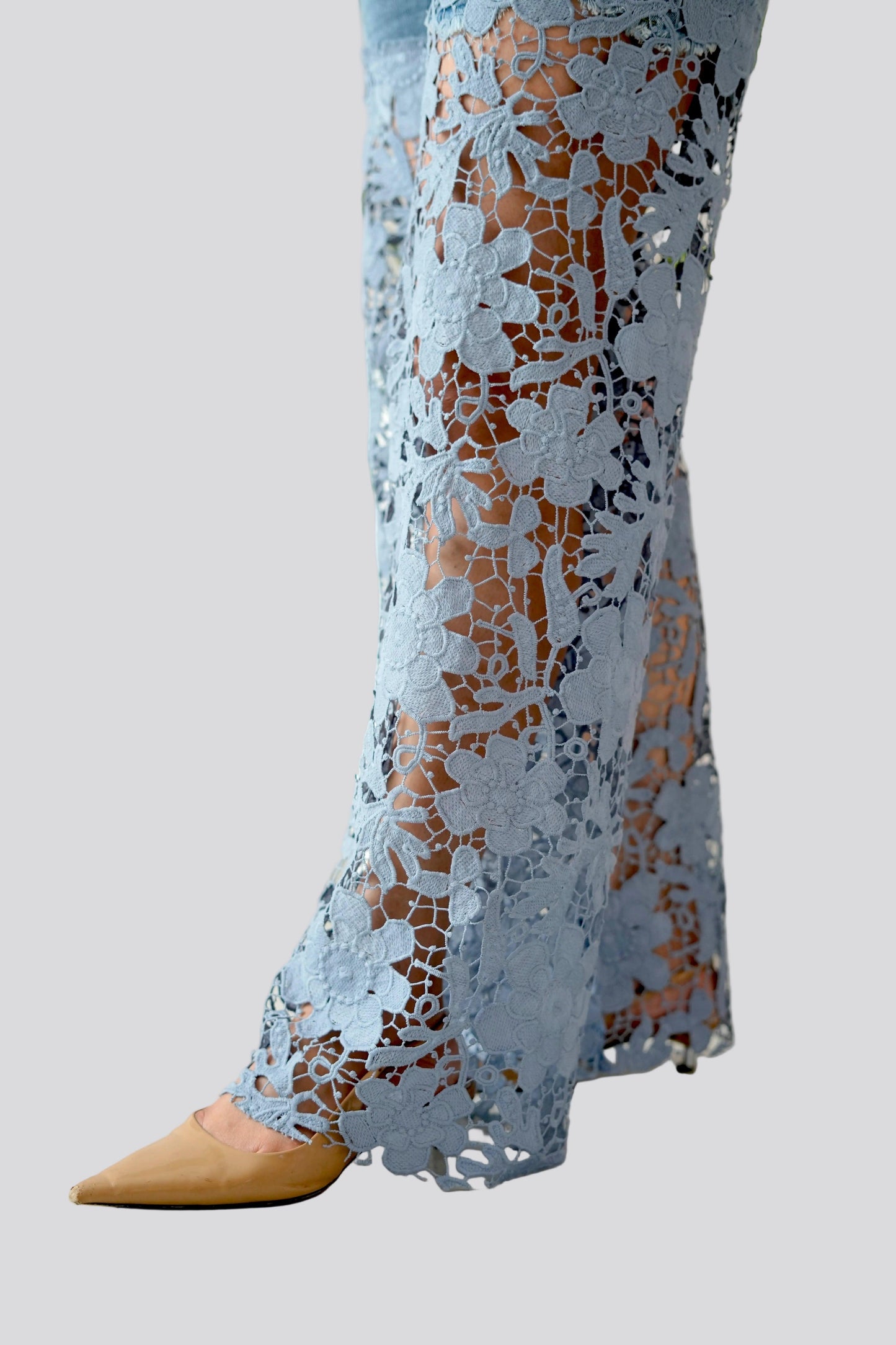 Light blue lace pants with a pattern on a white background