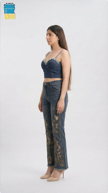 Woman wearing a denim outfit with lace details on a white background