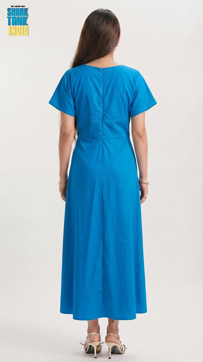 Woman wearing a blue dress with a plain background
