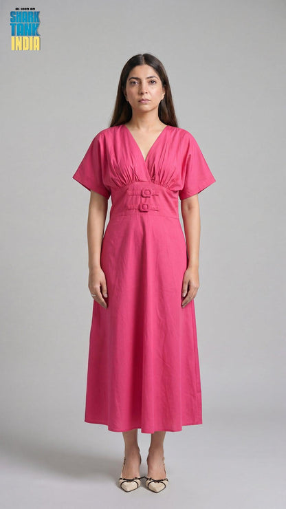 Woman wearing a pink dress against a gray background