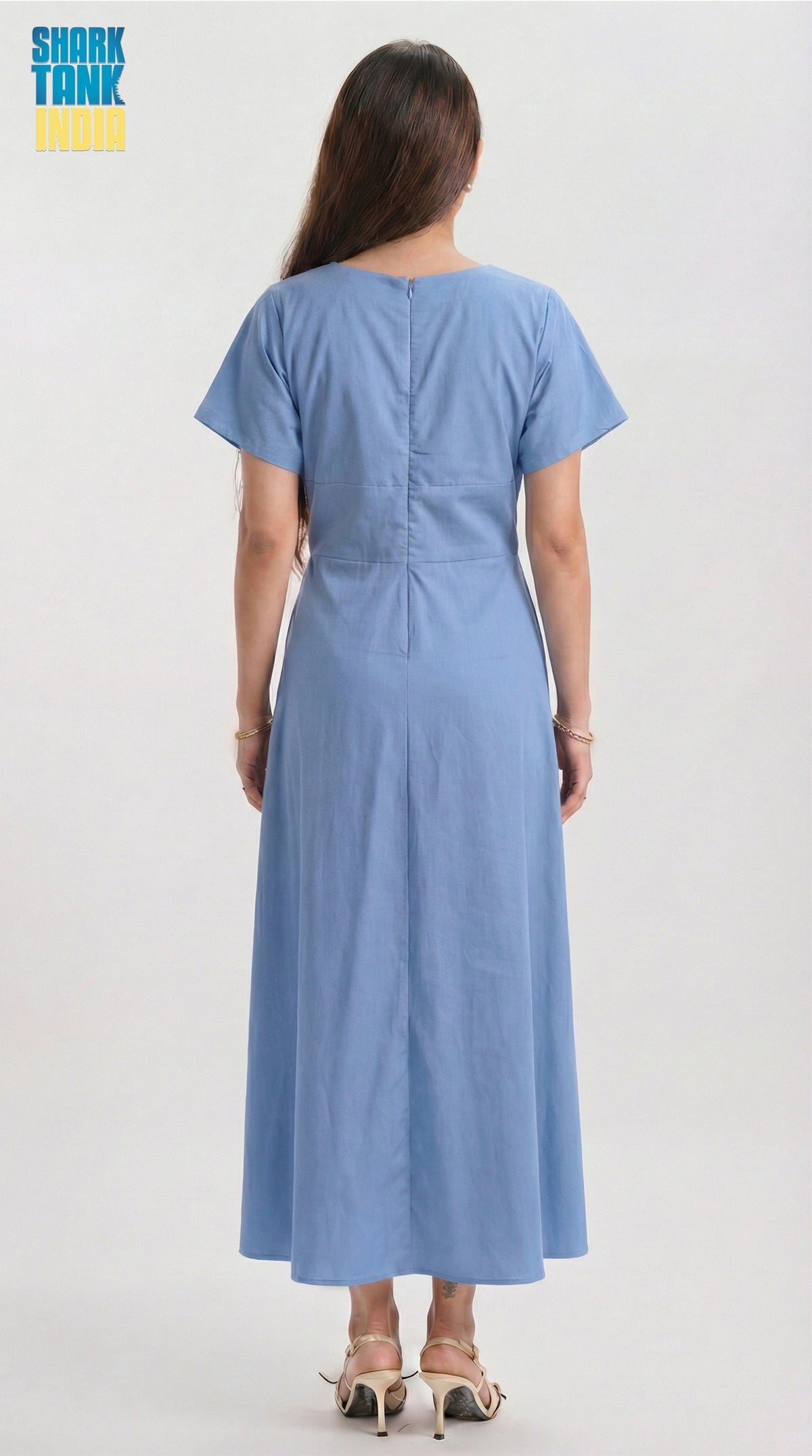 Woman wearing a blue dress from the back on a white background