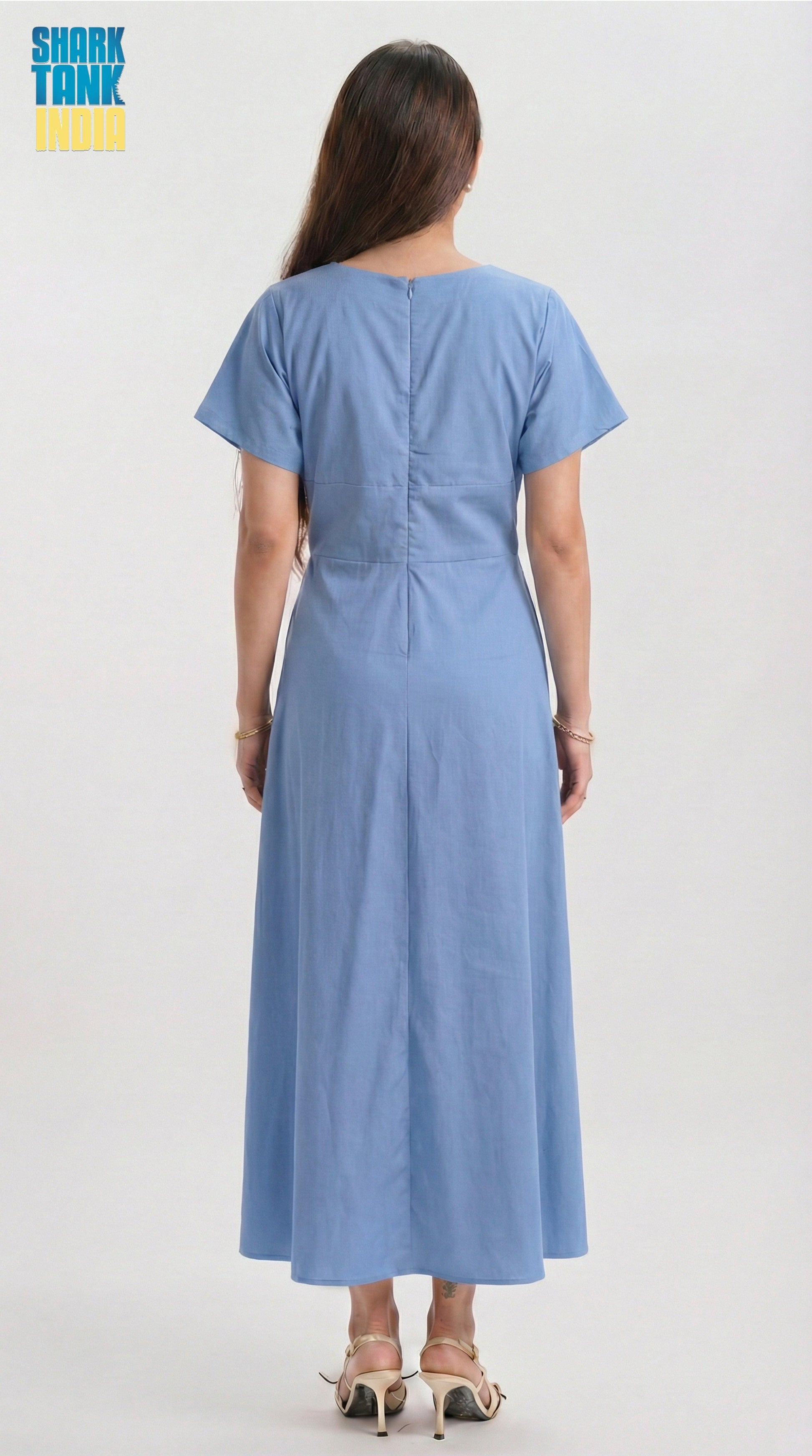Woman wearing a blue dress from the back on a white background