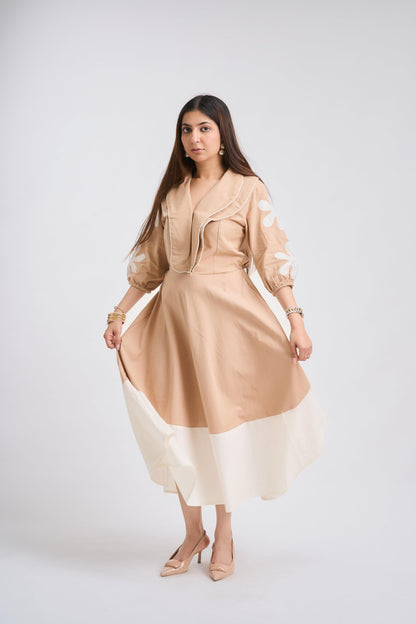 Woman wearing a beige and white dress on a white background