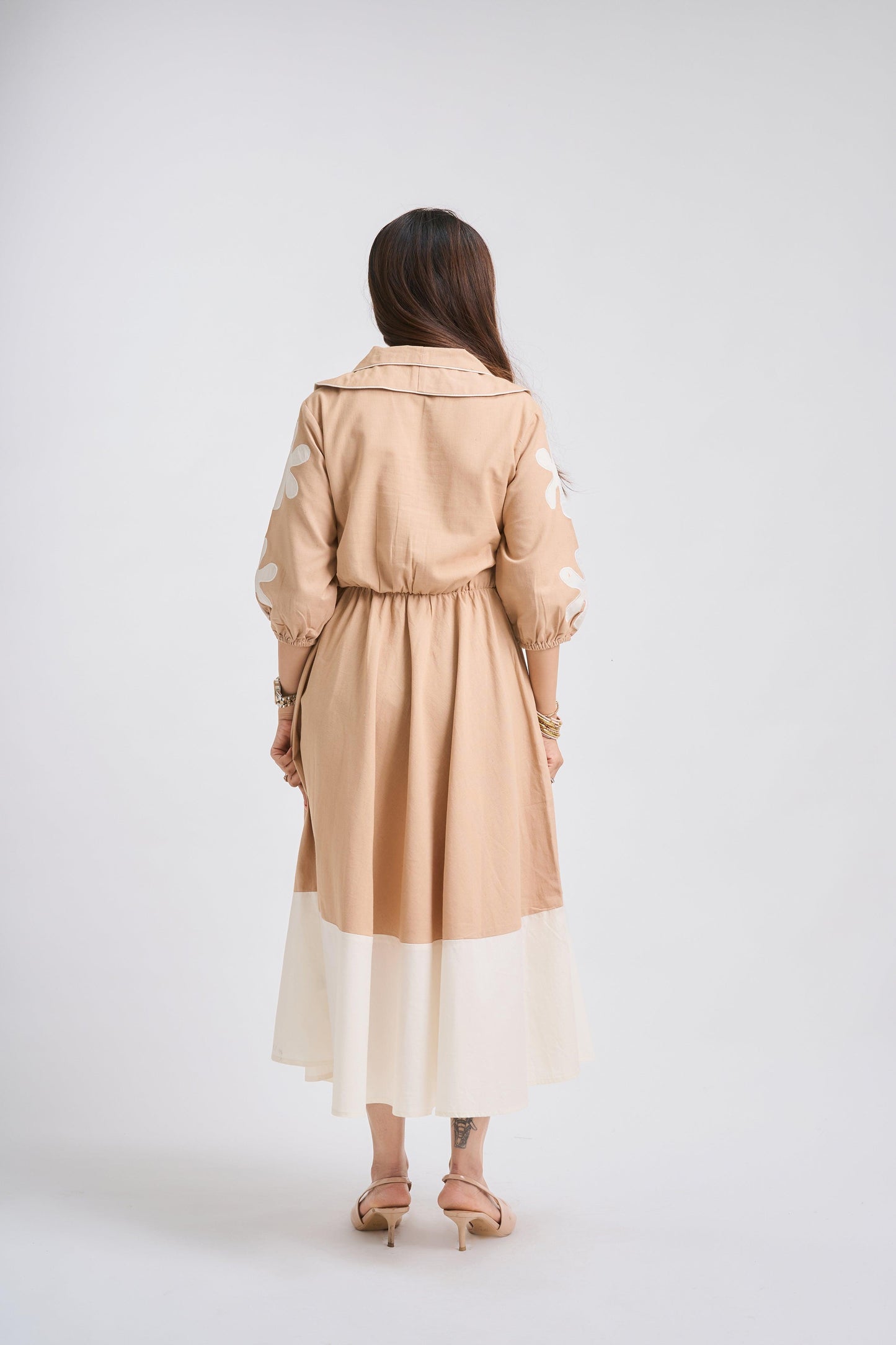 Woman wearing a beige trench coat on a white background