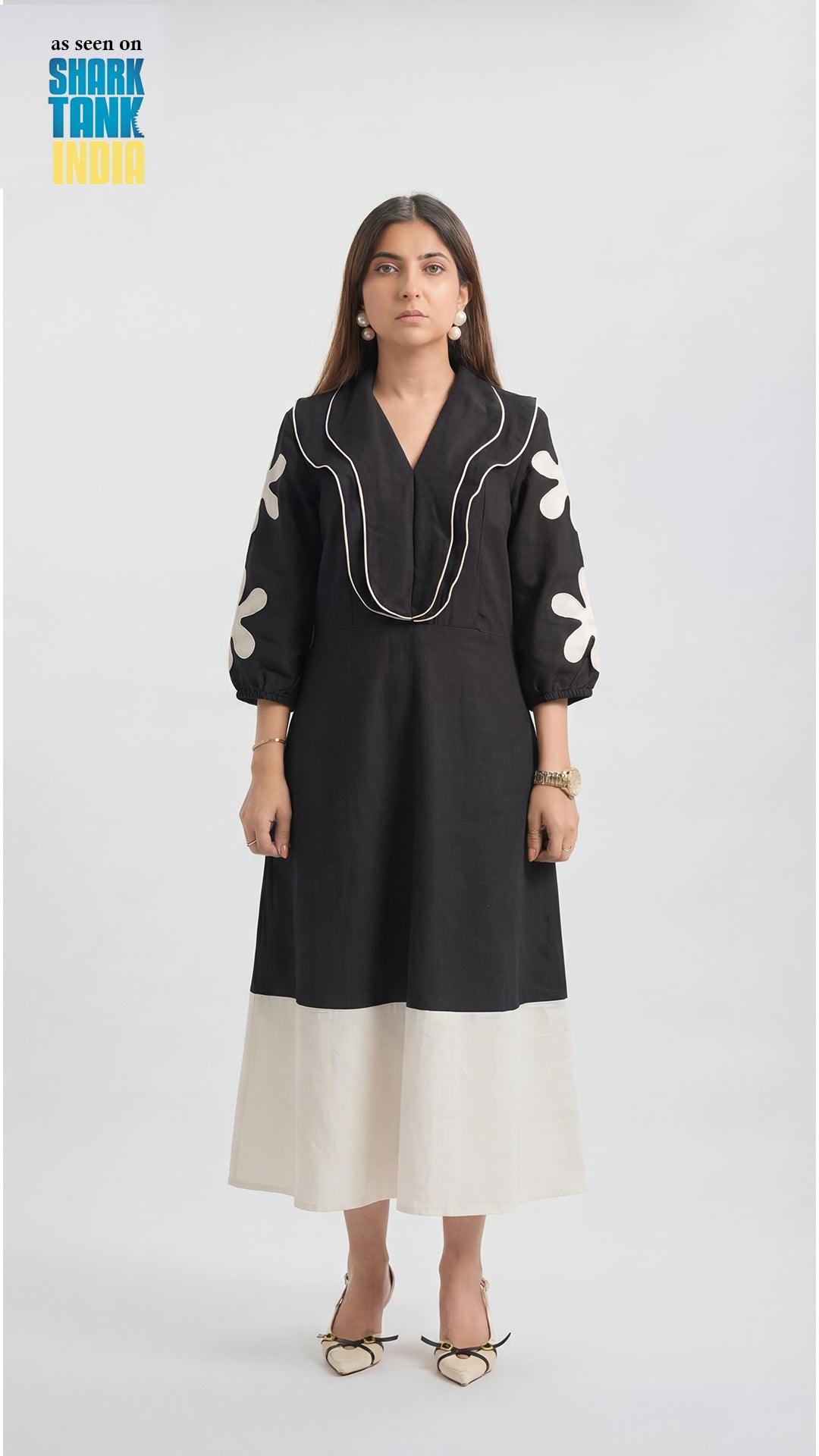 Woman wearing a black and white dress on a white background
