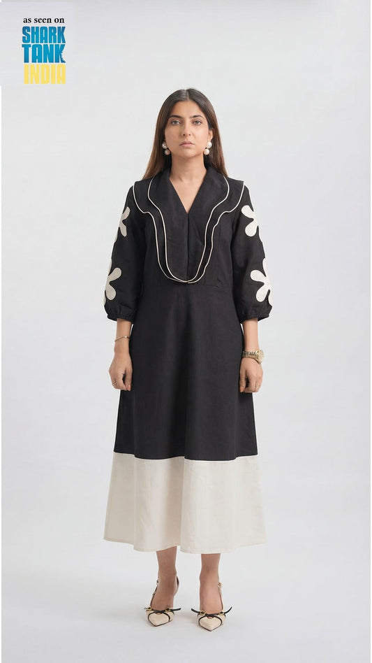 Woman wearing a black and white dress on a white background