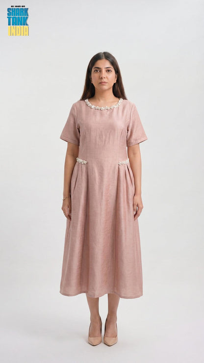 Woman wearing a pink dress with a white background