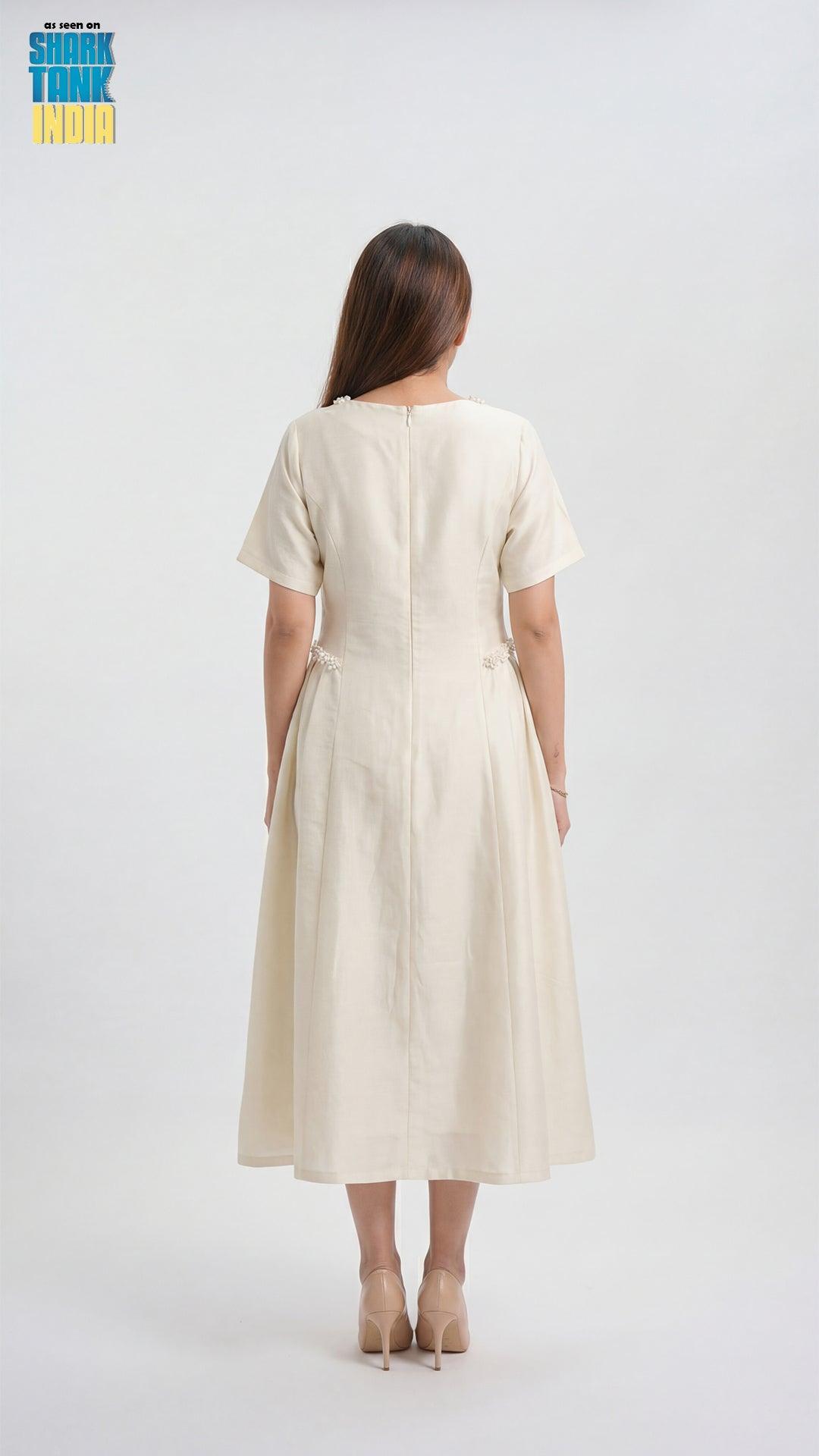 Woman wearing a beige dress on a white background