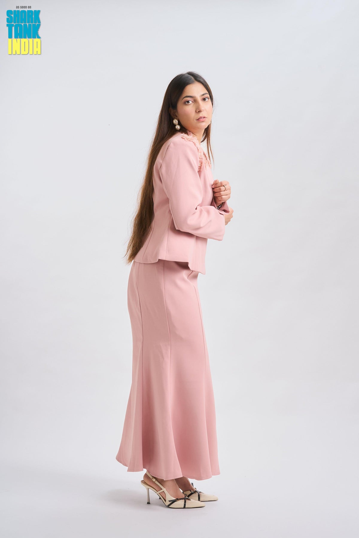 Woman wearing a pink suit on a white background