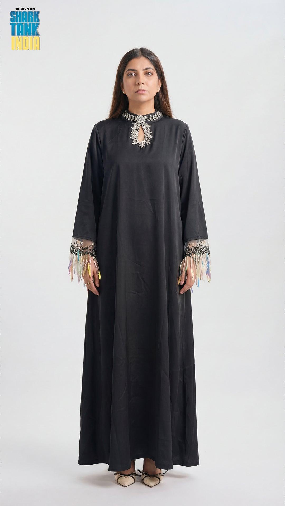 Woman wearing a black dress with embroidery on a white background